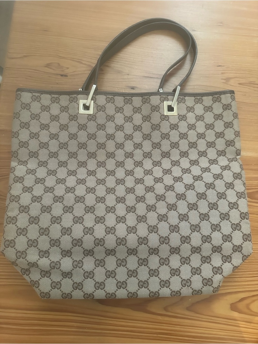Pre-loved Gucci Beige GG Canvas Tall Tote Bag with dark brown leather straps.